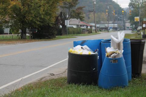 trash waiting for pickup outside a business on Bryson Walk