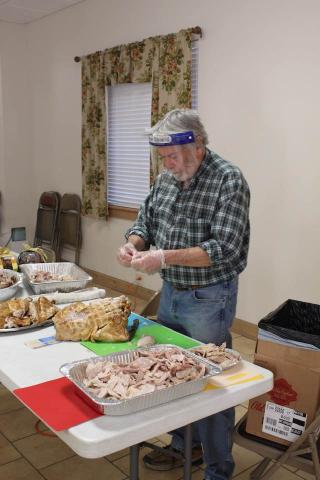 Volunteer Ken Jones helps divvy up the turkey. 