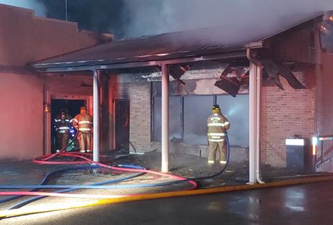 ocal firefighters fight a fire that started in the basement floor below the old service station section of a vacant funeral home on Main Street in the early hours of Saturday morning. 