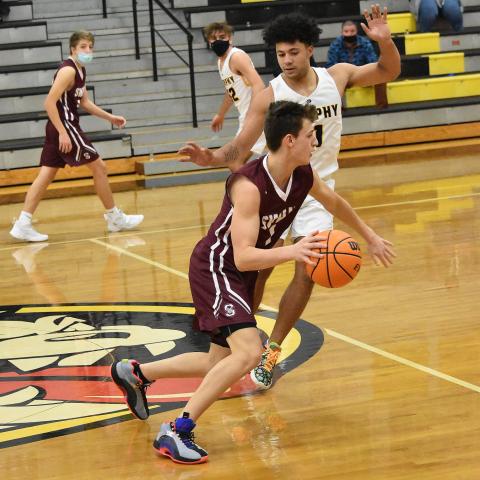 Maroon Devil Carter Kirkland, junior, advances the ball down the court in the Murphy away game that ended as a loss for the Devils despite the team scoring 79 points. 