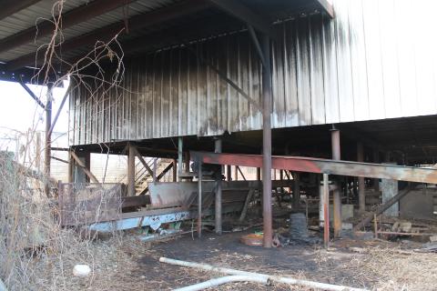 Smoke damage is visible on the metal siding of the building that was formerly operated as a lumber company. The cause is still under investigation, but arson is suspected. 