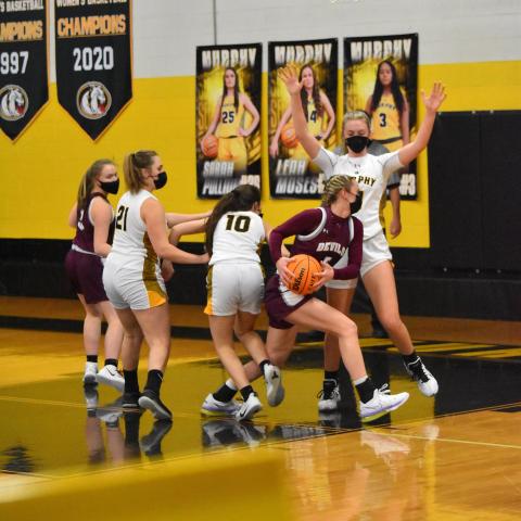 Lady Devil Mazie Helpman, junior, drives the ball and shoots and scores in the away 68-51 loss against Murphy on Friday night. 