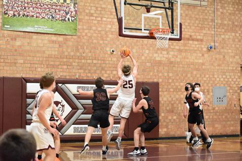 Maroon Devil Isaiah Collins closes in on the basket in the home court 84-41 win against Rosman. 