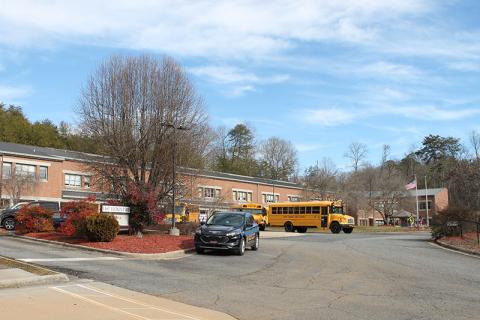 Buses are lined up outside East Elementary along with a Swain County SRO vehicle near the end of the school day on Monday. Elementary students in Swain County will be able to attend in-person four days a week beginning Monday, Feb. 22. 