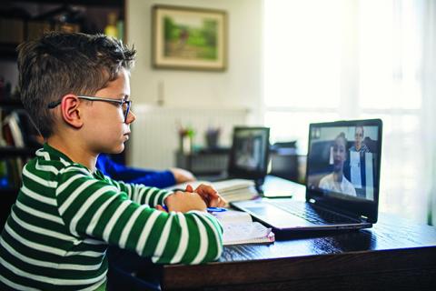 A boy works in front of a computer
