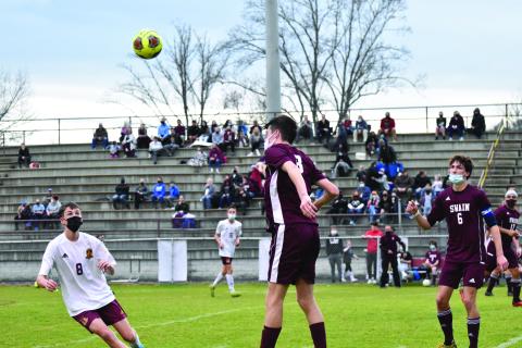 Levi Trantham jumps up to head the ball in last week’s game.
