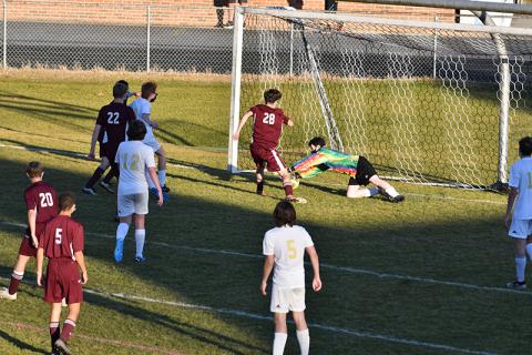 Photo by Chris Readman. Junior Lucas Trantham scores the final goal on the Hayesville Goalkeeper.