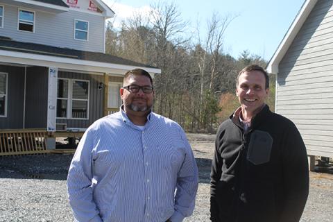 From left, Travis Smith,Kituwah Homes regional director of operations, and Jeremiah Wiggins, president, are pictured outside the eight model homes on the sales property that is located across the road from Food Lion in Cherokee. It’s slated to open in about a month. 