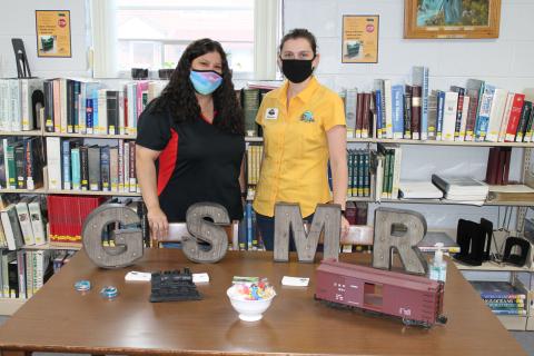 From left, Tasha Lee and Stephanie Rodeck represent Great Smoky Mountains Railroad at a hiring fair held at the Marianna Black Library last week. 