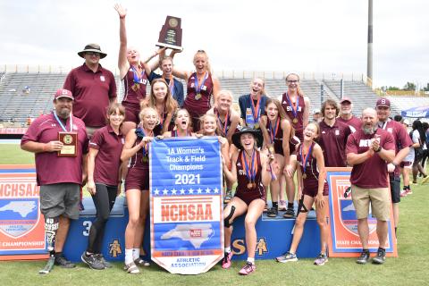 Lady Devils with coaches after winning state