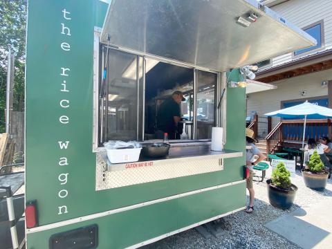Jeremiah Chatham, owner of The Rice Wagon, is pictured inside his establishment helping a customer.