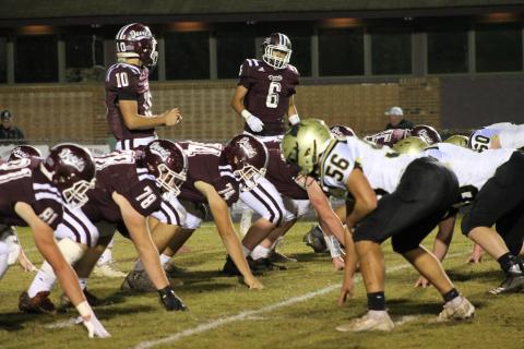 Maroon Devils Gabe Lillard and Donnavin Groenewold before the snap, while linemen hold position in the home win against the Yellow Jackets. 