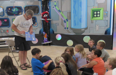 Wayne Dickert reads to students during the 2019 summer reading camp. The theme was “Reading Is Out of This World.”