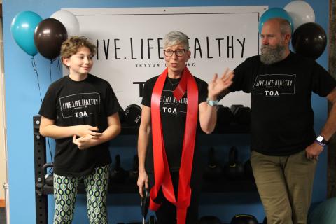 Shannon Royce, center, thanked her daughter Kenzie and husband Chris for all their help with opening her personal training studio, Live Life Healthy TOA,  during a ribbon cutting ceremony held Dec. 10. 