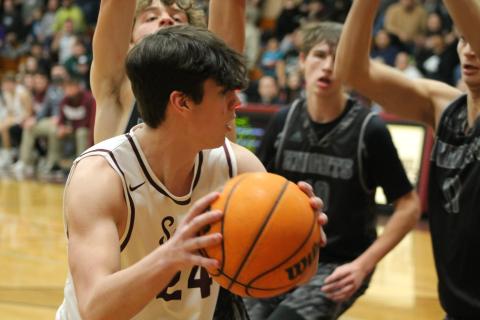 Nathan Bogdanowicz passes the ball to a teammate just as the Knights try to snatch it away in Tuesday night’s game.