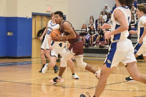 Maroon Devil Josiah Glaspie catches the pass and goes toward the basket at the away game vs. Smoky Mountain. Photo by Joanna McMahan/Swain Schools