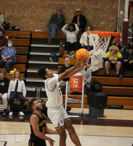 Maroon Devil Josiah Glaspie goes up for a basket with a Bulldog on his heels during the home game on Tuesday.