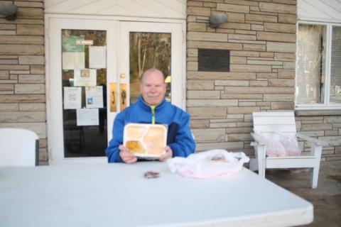 Mike Colcord, a volunteer with The Giving Spoon, gets ready to hand out meals at the Bryson City Presbyterian Church.Credit: Larry Griffin/SMT