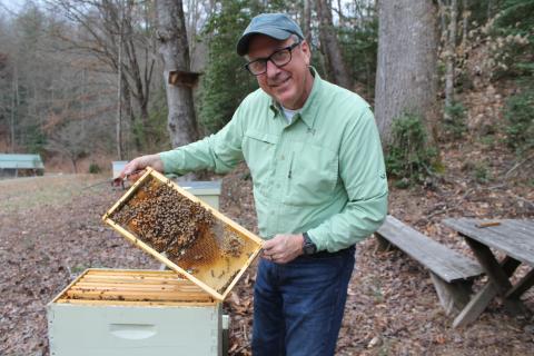 Fred Crawford, president of the Smoky Mountain Beekeepers Association, shows off one of his beehives at his farm in Whittier.