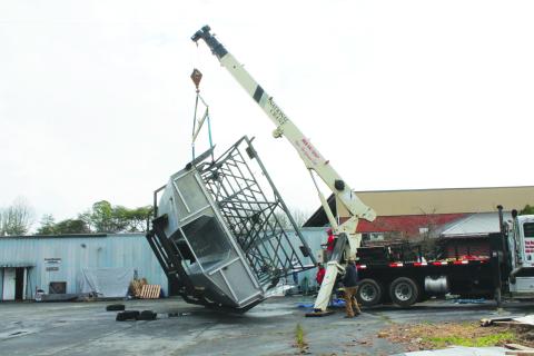 At Smoky Mountain Boatworks in Bryson City on Thursday, March 23, a Catamaran boat was flipped over by a crane, with inspectors intending to come by this week to make sure it’s ready for sailing in Albemarle Sound for passenger trips.