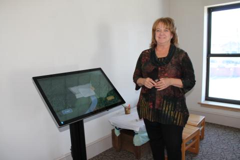 Mary Ann Shea shows off the new Story of Fontana Dam interactive display in the Heritage Museum.
