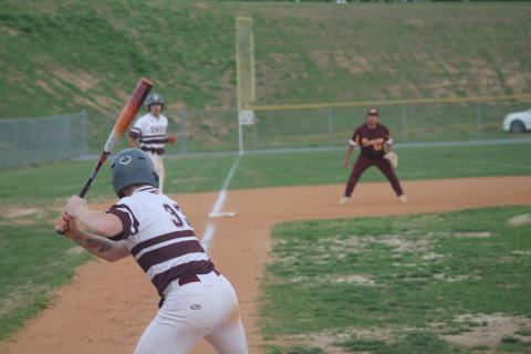 Carter Hayes is at bat at the baseball game April 5 as Gabe Lillard lingers on third, trying to come home.