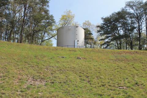 The high school water tower is located up the bank from the football field.