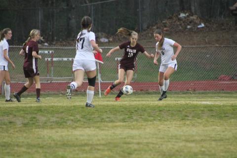 Lady Devil Mya Burrows-Kurr tries to navigate the ball away from Tuscola opponents.