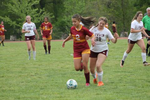 Rose Carson clashes with a Cherokee Braves player at Monday’s game.