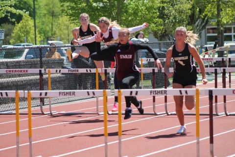 Lady Devils Melanie Linton (lead) and Kinsley Hyatt participating in one of the hurdle relay events at the SMC Track & Field Championships on May 3.