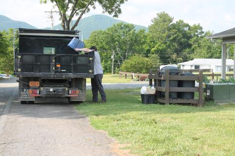 Bryson City town worker Logan McCall runs the residential recycling pick-up on Wednesday morning. He's pictured here collecting recyclables from homes on Hospital Hill.