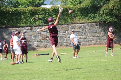 A football player gets some air catching the all