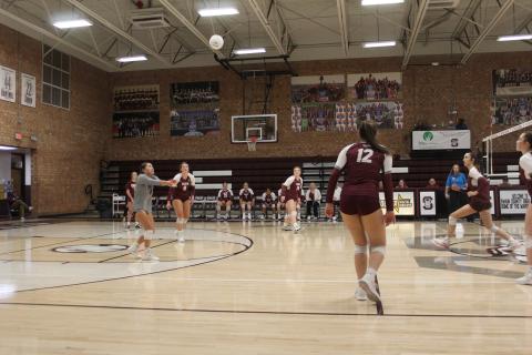 Lady Devils Izzy Walker (from left), Kennedy Anthony, Rylee Rawls and Carley Teesateskie watch the ball descend at the game Thursday, Sept. 21, in which they beat the Robbinsville Black Knights.