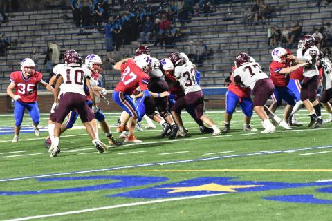 Keyanthae Graham (from left), Mason Cochran, Andreas Cisneros and Skeet Cook grapple with opponents from the Madison Patriots at the game Sept. 22. The Devils won in 35-16.