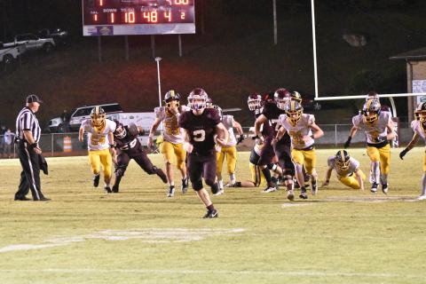 Josh Collins runs with the ball at the home game against Murphy on Friday, Oct. 13. The Maroon Devils won the game by 37-13 and are still undefeated. Collins has been doing well with rushing this season – he ran 265 yards over 23 carries this game, his third game in a row where he ran more than 200 yards.