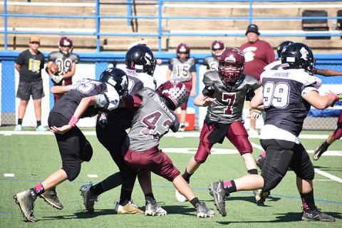 Swain Midget Malakii Otero, 11, prevents a Knights advance.