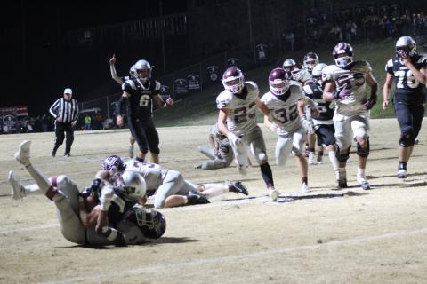Maroon Devils sophomore Skeet Cook (from left), junior Mason Cochran and sophomore Drew Skaggs run toward the action at the away game in Robbinsville on Friday, Nov. 17