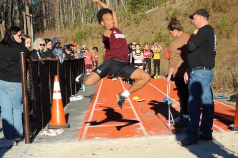 Sophomore Zeke Glaspie performs the high jump at the Dec. 7 track meet. He got a mark of 18-11, coming in first place at the meet.