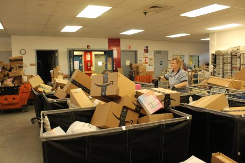 Postal worker Angie Gibby sorts through the numerous package deliveries ready to go out in mid-December.