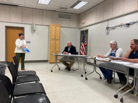 From left, Amy Vasquez speaks to commissioners during public comment about the need for animal control. County manager Kevin King and commissioners David Loftis and Kenneth Parton listen. 