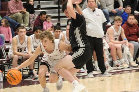 Sophomore Druw Cody tries to break through the Black Knights’ defense to get to the hoop at the game played at home Friday, Feb. 9.