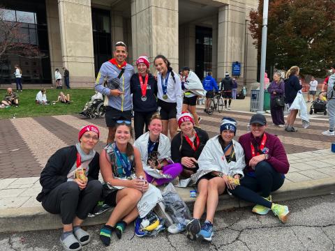 Kallup McCoy (2nd row left) is pictured with his team of athletes he coaches after the Indianapolis Marathon this past October, including his wife Katelynn Ledford-McCoy (1st row, 3rd from left).