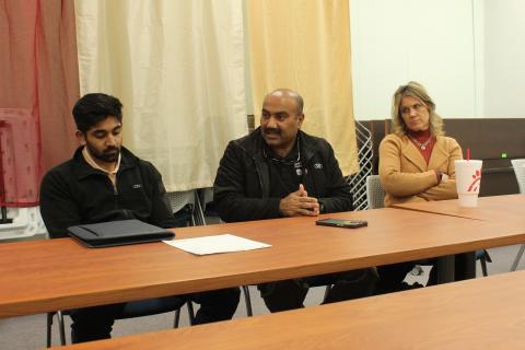 Mark’s Pharmacy owner Mark Adam (center) sits with his son Faisal Adam and pharmacy partner Christy Kirkpatrick at the town hall meeting at the library Thursday, Feb. 8.
