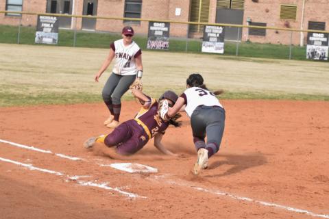Freshman Allie Stephenson (front) tags out a Lady Braves opponent at the home game Monday, March 25.