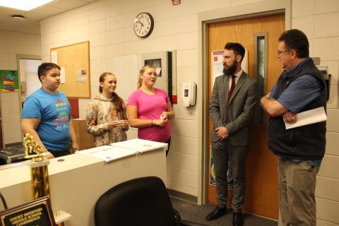 Swain County Middle School students Conner Bowman (from left), Cara Aldridge and Brylee Shuler greeted Sen. Kevin Corbin (far right) for a walkthrough of the middle school on Thursday, March 7. Middle school principal Ryan McMahan (middle) was glad to welcome the legislator.