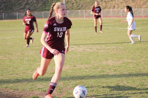 Junior Mya Burrows-Kurr on the move with the ball at the game Thursday, March 21 against Tri-County Early College. The Lady Devils won the game 9-0 when the mercy rule was invoked in the second half.