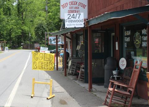 A handwritten sign outside Deep Creek Store that was annexed into Bryson City town limits last year advertises the store now sells ‘Cold Beer.’