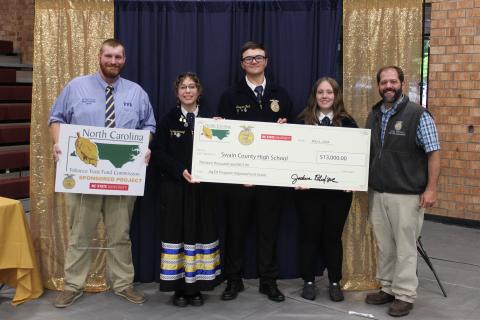Jessica Webb/SMT Swain County High School’s FFA was awarded a check of $13,000 from the North Carolina Tobacco Trust Fund presented by Western Region Agriculture Education Coordinator Andy VonCanon during the FFA’s banquet held at the high school gym this past Friday. Pictured from left is FFA advisor Toby Sorrell, 23-24 president Eva Bottchenbaugh, secretary Greyson Beck and parliamentarian Lily Craig with Mr. VonCanon. 