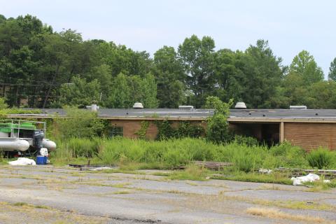 According to the county, the previous property owner is responsible for demolishing the old building on Black Hill Road where the school system plans to build a new middle school.