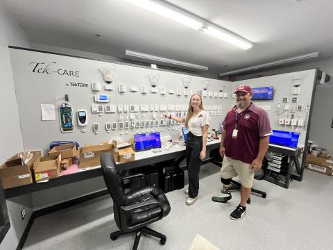 Swain High's Ian Roper takes a tour at TekTone with Amber Mauthe, technical support manager, as part of the Kenan Fellows Program. 